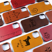 A wide assortment of leather iPhone cases are laid out in a grid-like pattern against a white background. Genuine leather phone case, engraved leather phone case, phone case for iPhone 15, engraved phone accessories, personalized phone case for him, personalized phone case for her, custom phone case for wife, custom phone case for husband 