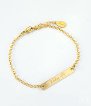 Single gold filled paw print with name engraved in script font. 