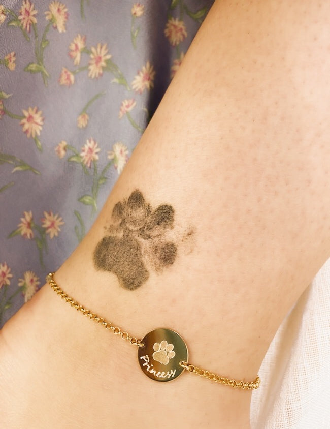 Perfect gift for any animal lover. The model is sporting our paw print anklet in gold filled with hand  script writing. 