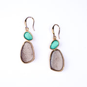 Two Tone Rose Gold Earrings painted in teal and gray against a white background