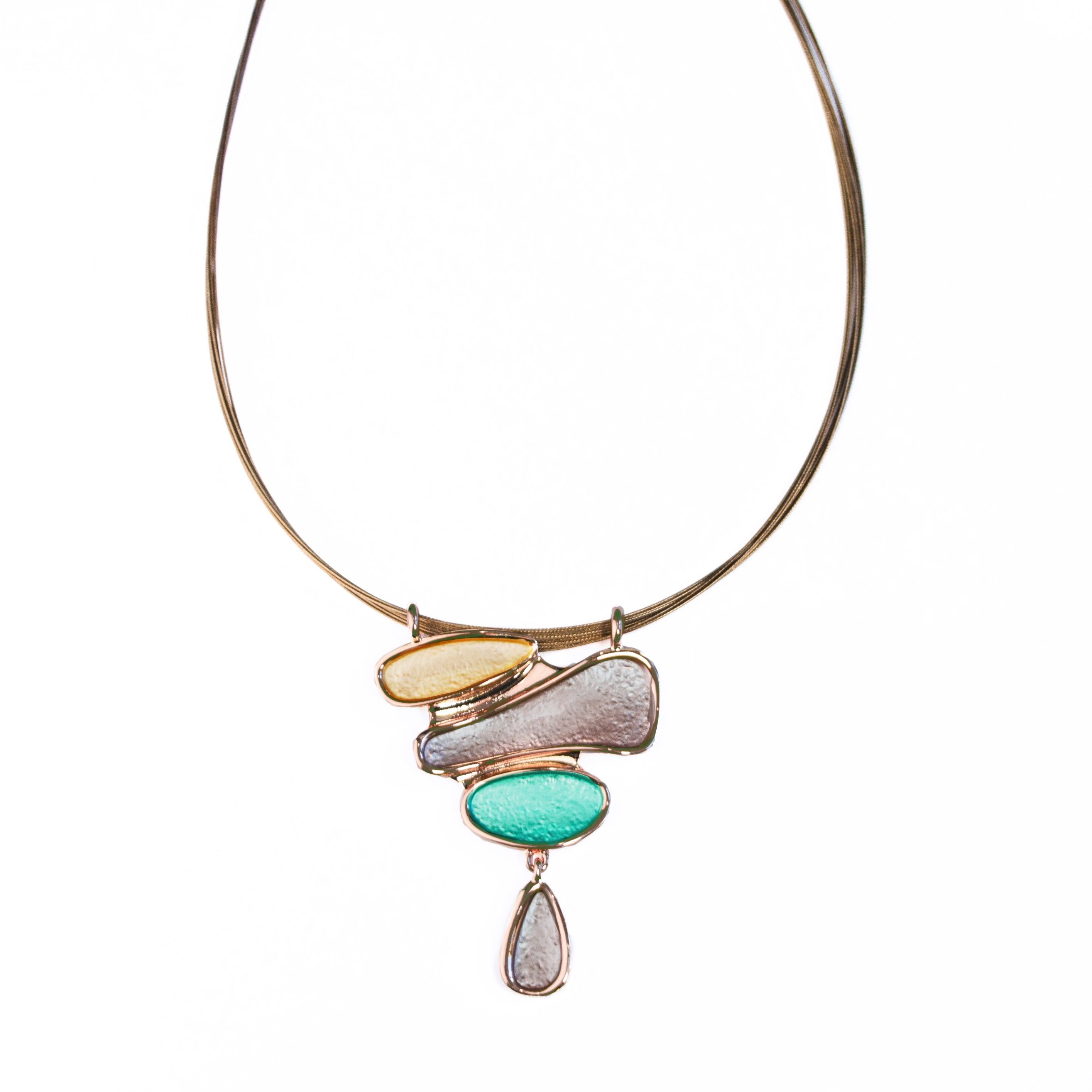 Necklace with a rose gold pendant with three organic shapes and a dangling teardrop painted in gold, brown, and teal. Necklace has a copper wire chain. Boho Style Necklace with color blocking.