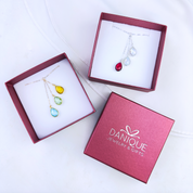 2 lariat necklaces in open danique jewelry boxes. Personalized lariat necklace, cascading birthstone pendant, gold lariat birthstone necklace, silver lariat jewelry, rose gold birthstone necklace, custom birthstone necklace, family birthstone jewelry, unique lariat necklace, gift for mom, stylish gemstone lariat