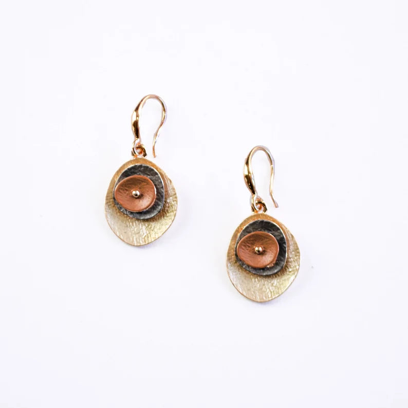 A pair of red and brown rose gold abstract flower earrings against a white background. Earth toned boho jewelry is the best addition to a seemingly complete jewelry collection - with shapes that are sure to catch the eyes of your friends! These lightweight floral earrings come ready for gifting - with fast shipping options for speedy delivery. 