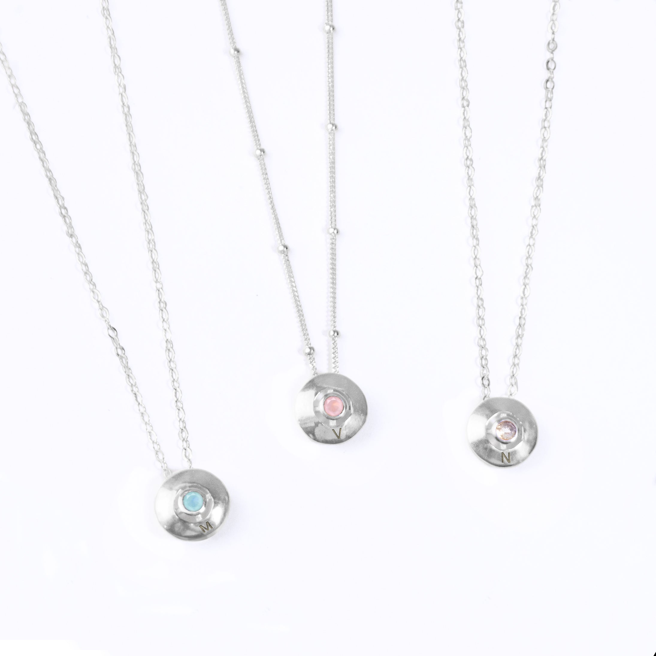 Three Necklaces with Bezel Set Round Pendants Engraved with Initials. All Parts are 925 Sterling Silver. From Left to Right: Aqua Chalcedony Pendant and cable chain, Pink Chalcedony Pendant and Satellite Chain, Opalite Pendant and cable chain