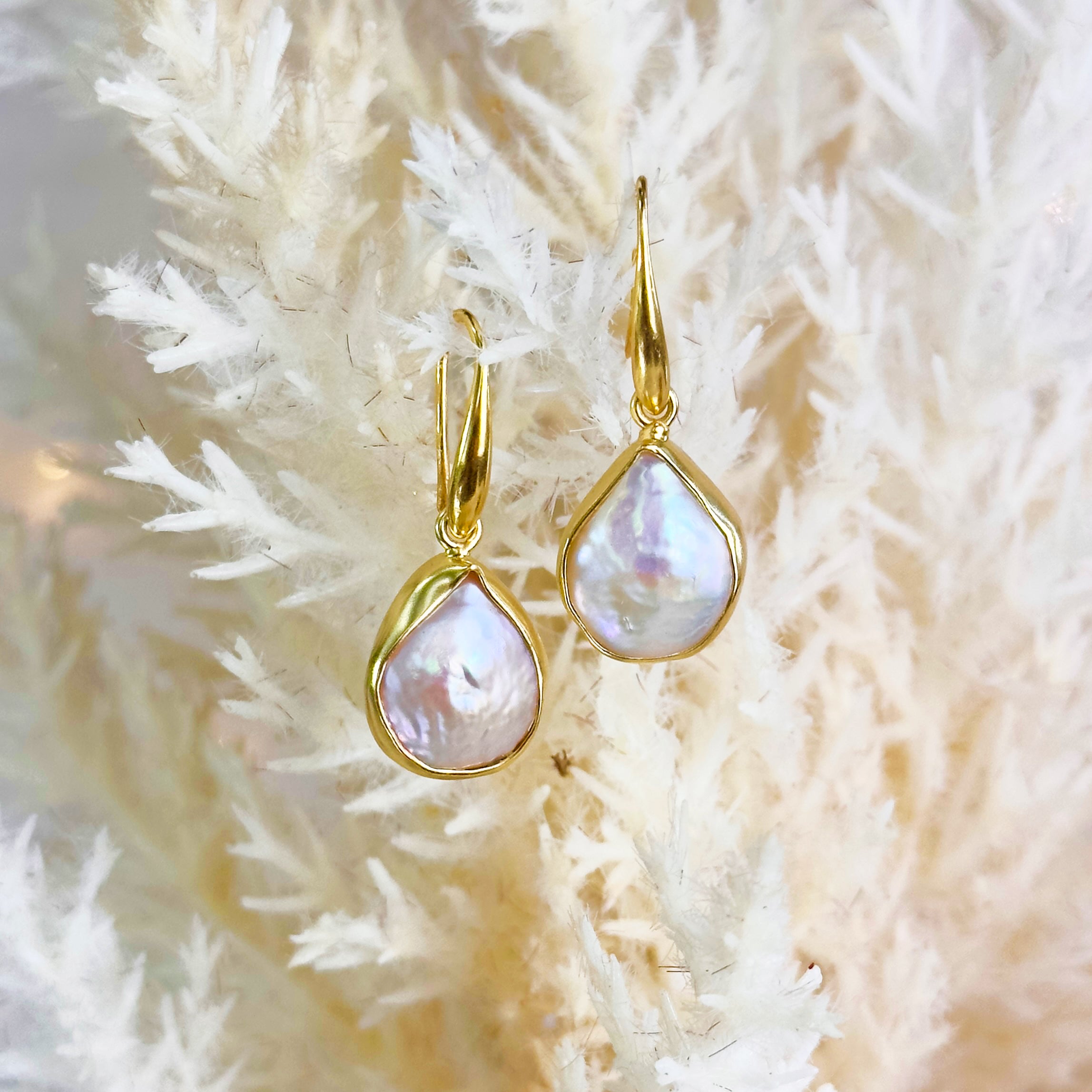 A pair of Boho Gold Mother of Pearl Teardrop Choker Earrings hanging. pearl pendant, pearl earrings, pearl necklace, boho jewelry, statement earrings, statement necklace, pearls, bohemian jewelry