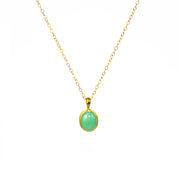 A Mint Green Chrysoprase cabochon necklace in vermeil gold hangs on a Gold Filled Cable Chain against a white background. Shimmering Golden Mint Green Chrysoprase Necklace, Dainty Gold Gemstone Necklace