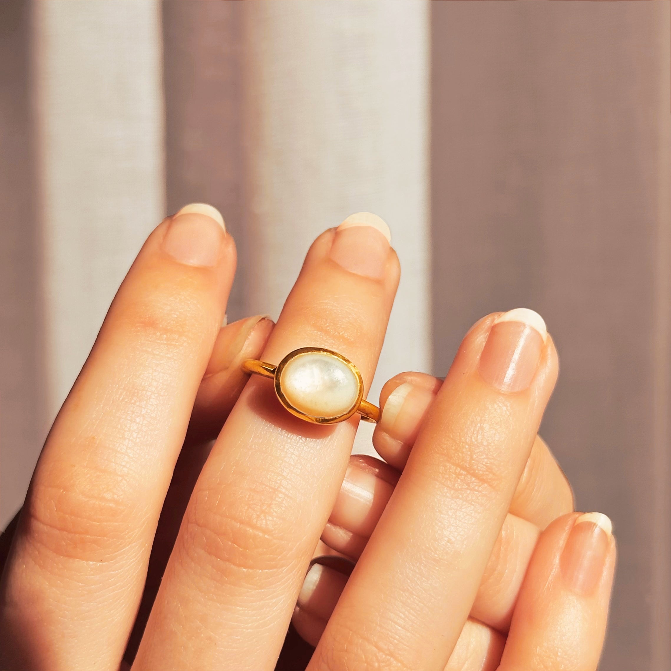 Model placing an iridescent mother of pearl cabochon ring on hand. Vermeil Gold Mother of Pearl Oval Ring, Summer Jewelry, Beach Jewelry, Bridal Jewelry, Mother of Pearl Oval Solitaire Ring, Dainty Gold Stacking Ring Gift for Her