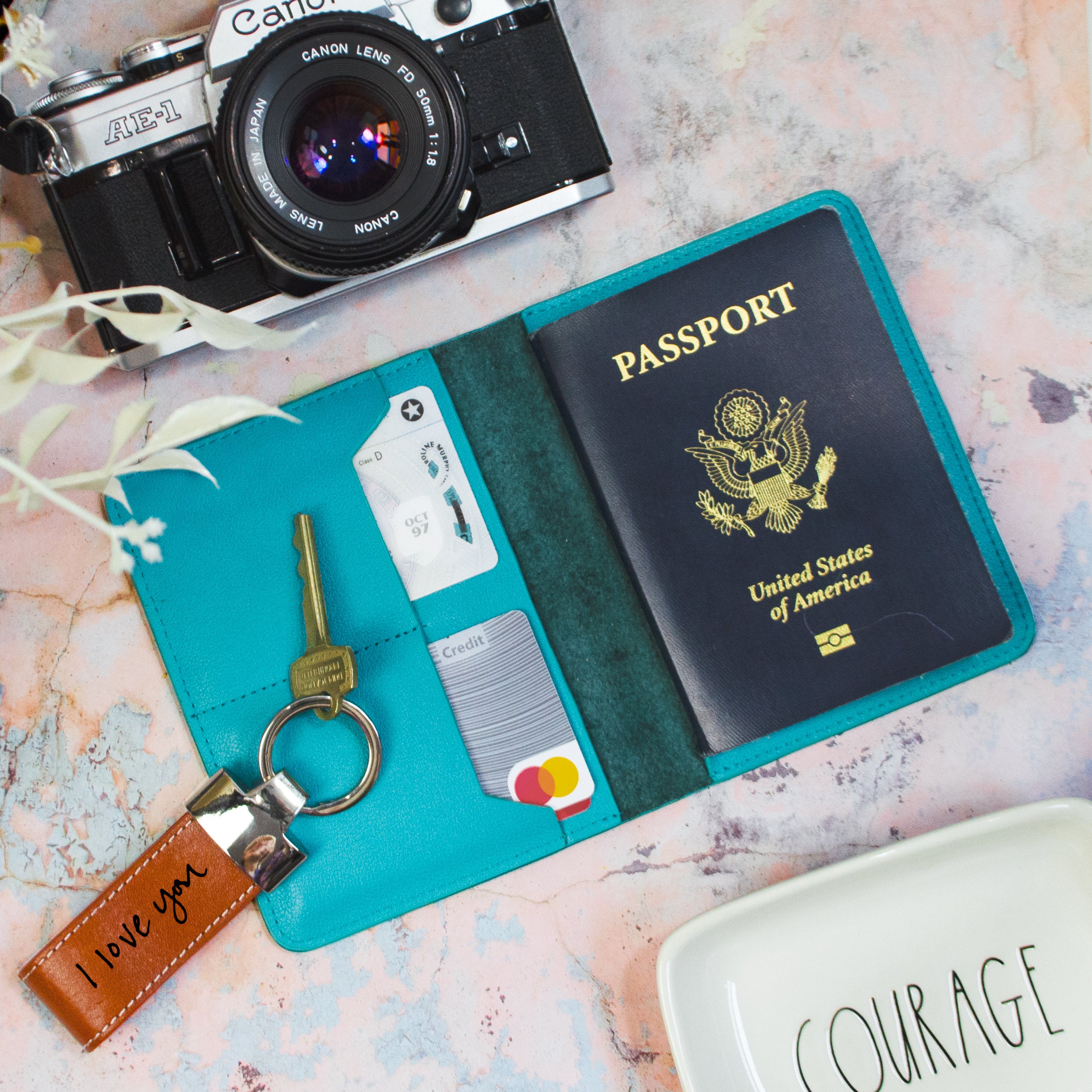 Bright Blue Turquoise High Quality Leather Passport Holder lies open flat with Two Card Pockets for ID Cards and a pocket holding a United States Passport