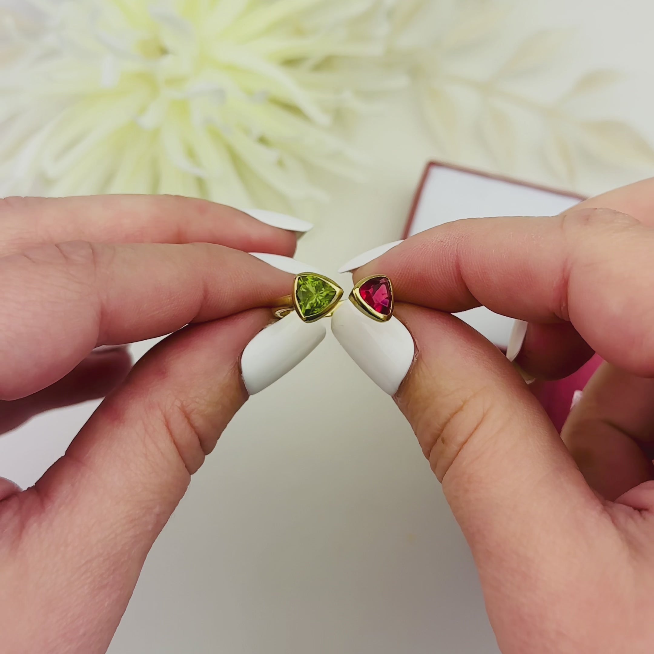 A video showing triangle bow tie rings. Personalized birthstone ring, dual birthstone ring. custom peridot, ruby, amethyst, kyanite, moonstone, blue topaz, garnet ring