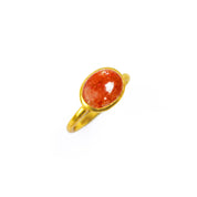 A bright orange sunstone shimmers  in a gold bezel set ring. The ring sits against a white background to let the rich orange color pop. 18K Vermeil Gold Large Oval Ring Bezel Set with a glittering orange Sunstone cabochon stone on a white background. Orange Sparkling Gemstone Ring, Dainty Gold Ring, Stacking Sunstone Ring, Luck Aura Cleansing Gemstone Ring