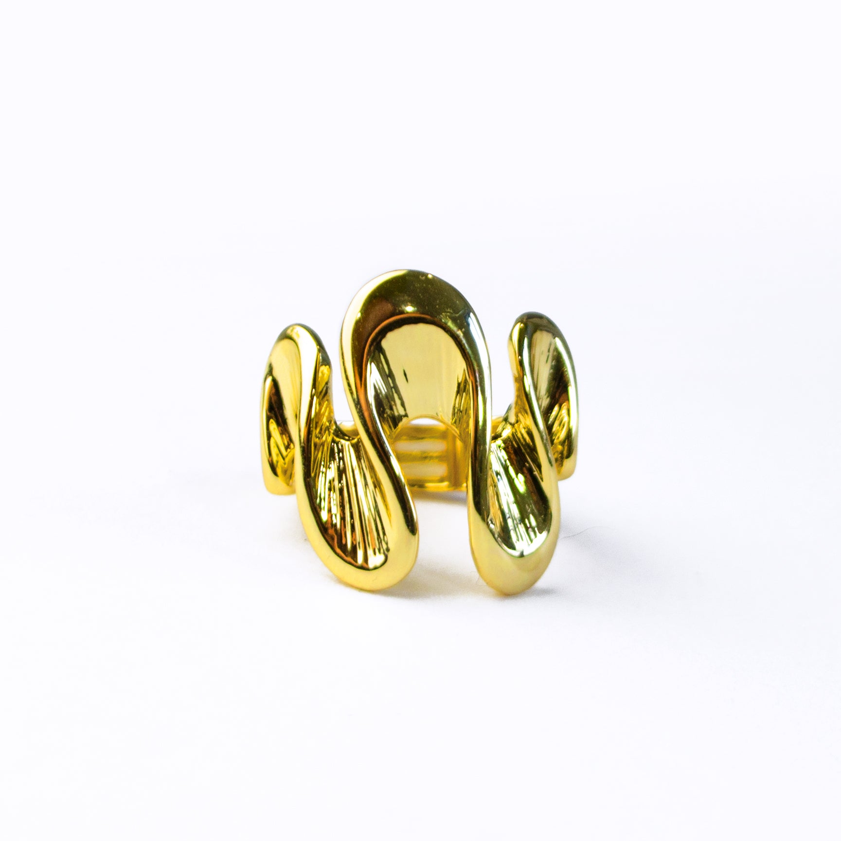 boho style gold wave shaped ring on a white background