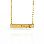 A gold pet name and paw print necklace. Engraved pet bar necklace, personalized pet memorial jewelry, sterling silver pet necklace, gold-filled pet necklace, rose gold-filled bar necklace, custom pet keepsake, dog or cat name necklace, pet lover gift, engraved front or back, pet loss gift, pet remembrance jewelry