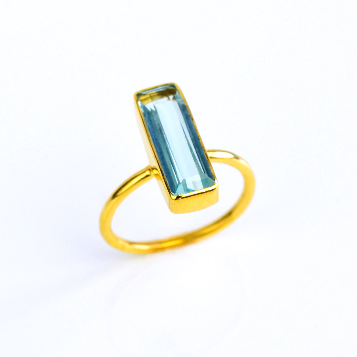 Blue Topaz ring, December birthstone jewelry, vibrant blue gemstone, unique Blue Topaz bar ring, minimalist design, bezel-set Topaz, Adira Series, eye-catching blue gemstone, stylish jewelry, elegant Topaz accessory