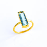 Blue Topaz ring, December birthstone jewelry, vibrant blue gemstone, unique Blue Topaz bar ring, minimalist design, bezel-set Topaz, Adira Series, eye-catching blue gemstone, stylish jewelry, elegant Topaz accessory