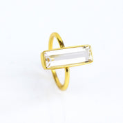 A gold gemstone bar ring shows off clear quartz. Personalized clear quartz bar ring, gold silver rose gold, handmade jewelry, April birthstone, birthday gift for sister, mother, best friend, Christmas gift, clear crystal ring, positivity jewelry, custom diamond alt ring, unique gemstone, meaningful jewelry gift