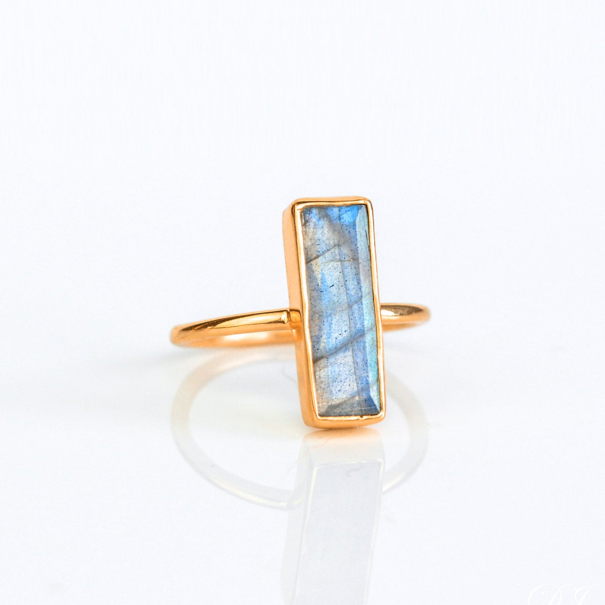 Labradorite gemstone ring, shimmering iridescent labradorite, unique bar ring, minimalist jewelry, bezel-set labradorite, Adira Series ring, stylish gemstone accessory, eye-catching labradorite, elegant iridescent ring, fashion-forward labradorite