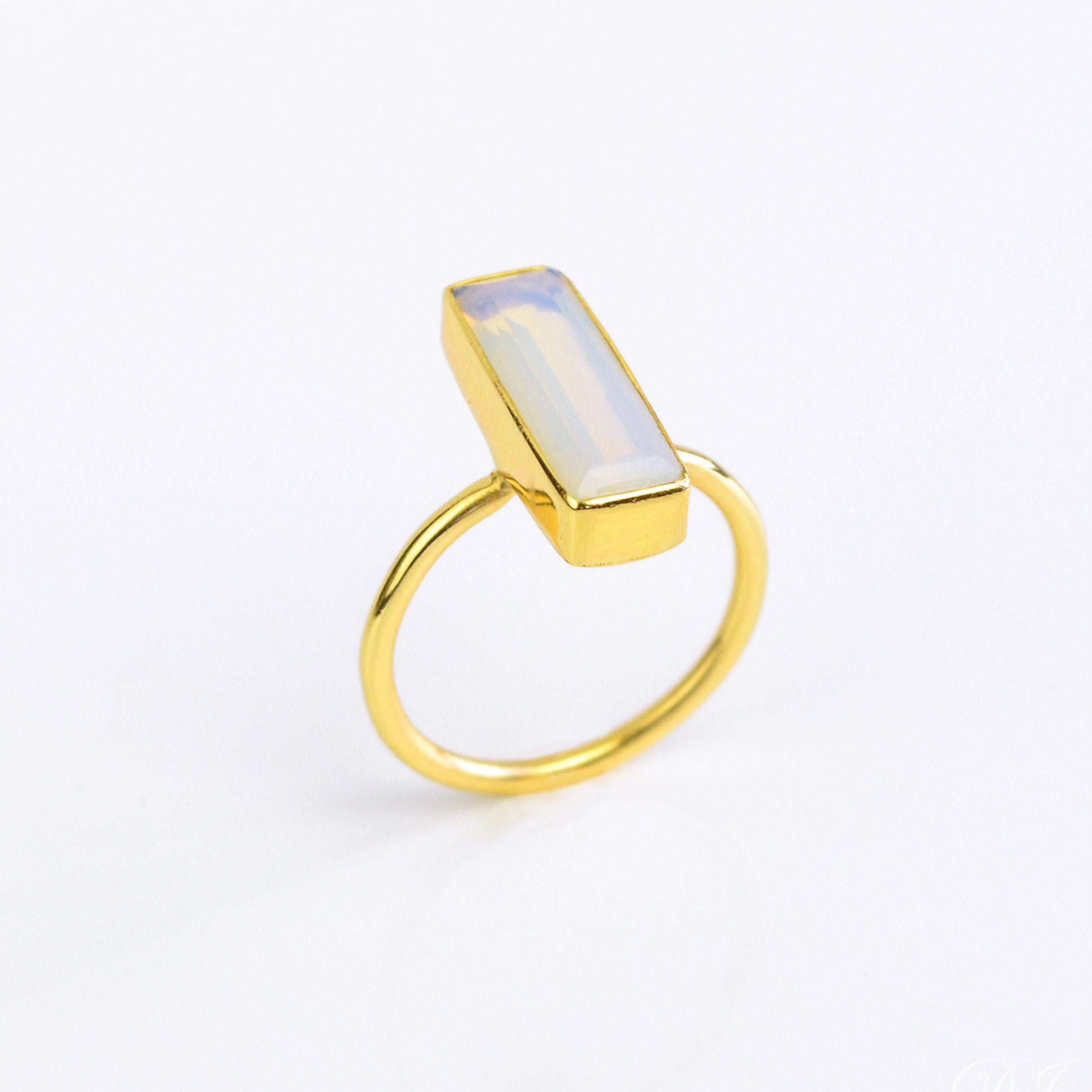 Opalite ring, October birthstone alternative, iridescent gemstone jewelry, unique Opalite bar ring, minimalist design, shimmering Opalite, bezel-set gemstone, Adira Series, eye-catching Opalite jewelry, stylish iridescent ring, elegant Opalite accessory