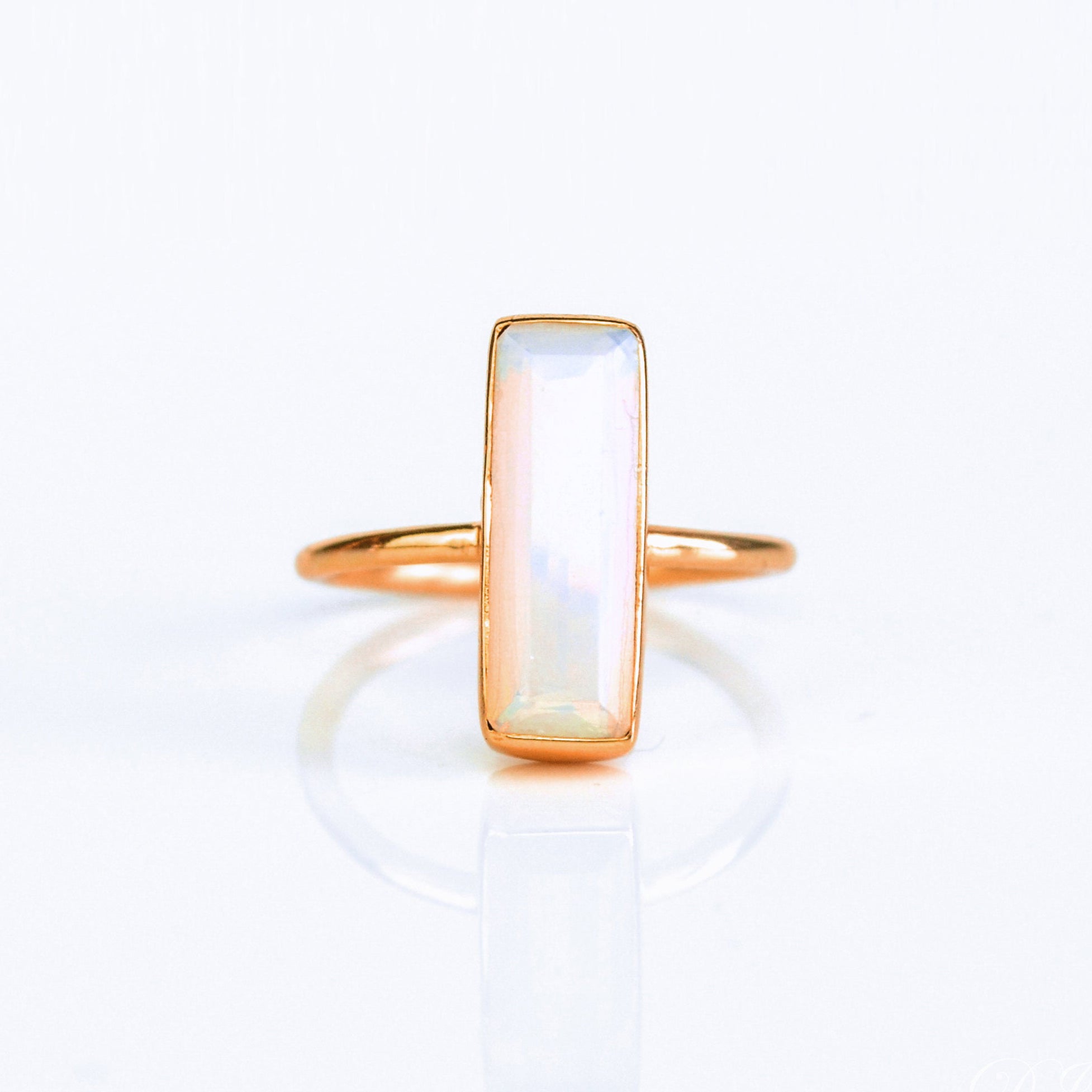 Opalite gemstone ring, shimmering iridescent Opalite, October birthstone alternative, unique bar ring, minimalist design, bezel-set Opalite, Adira Series ring, stylish iridescent jewelry, eye-catching Opalite, elegant gemstone accessory