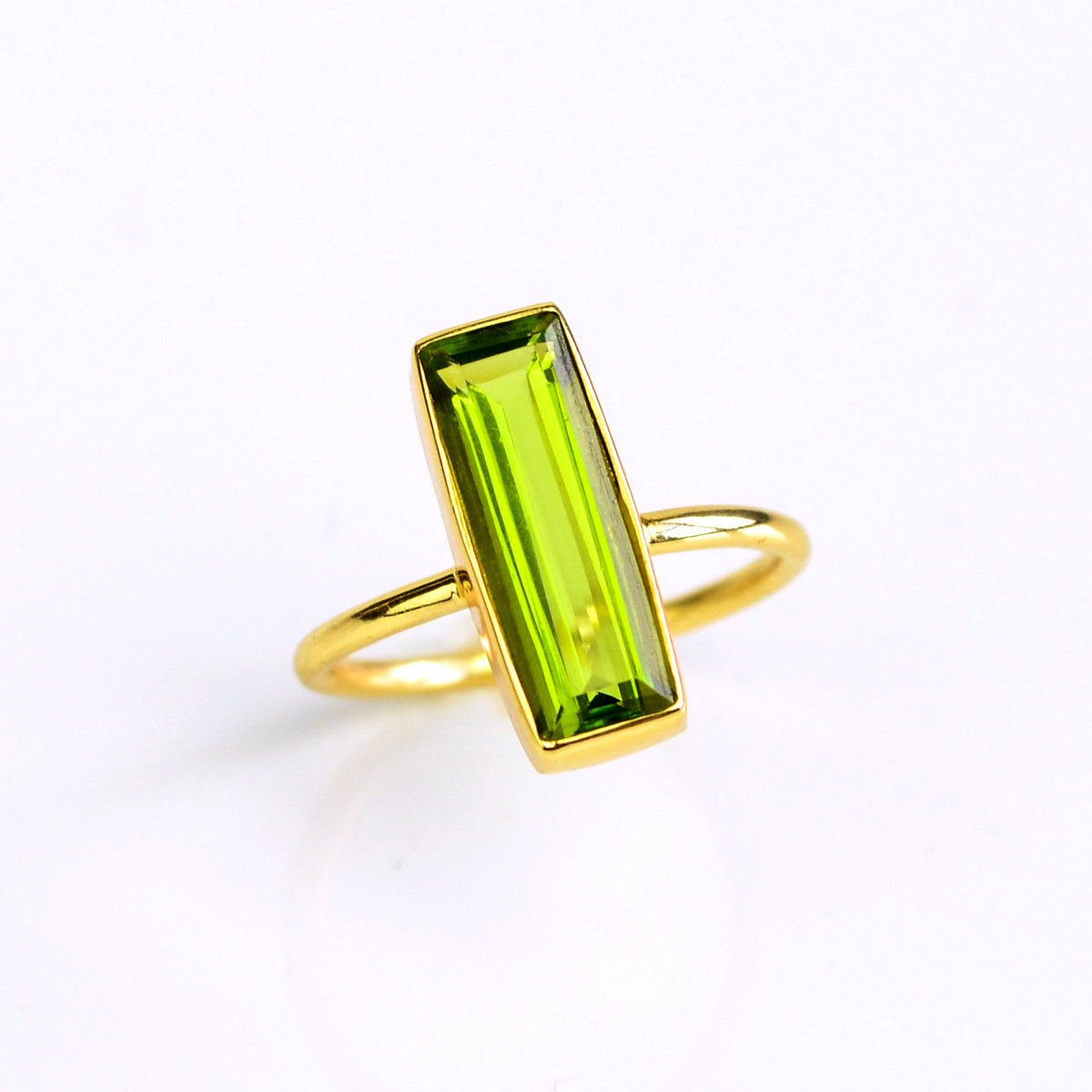 Peridot gemstone bar ring, August birthstone alternative, vibrant green Peridot, unique minimalist design, bezel-set Peridot, Adira Series, stylish green jewelry, eye-catching Peridot ring, elegant gemstone accessory, fashion-forward Peridot