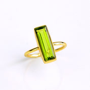 Peridot gemstone bar ring, August birthstone alternative, vibrant green Peridot, unique minimalist design, bezel-set Peridot, Adira Series, stylish green jewelry, eye-catching Peridot ring, elegant gemstone accessory, fashion-forward Peridot