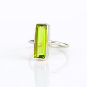 Green Peridot gemstone ring, August birthstone, unique bar design, vibrant green jewelry, minimalist Peridot ring, bezel-set gemstone, Adira Series, fashionable Peridot ring, elegant green gemstone, eye-catching jewelry