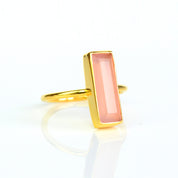 Pink Chalcedony bar ring, October birthstone jewelry, soft pink Chalcedony gemstone, unique design, minimalist ring, bezel-set stone, Adira Series, stylish pink Chalcedony, elegant jewelry, eye-catching gemstone accessory