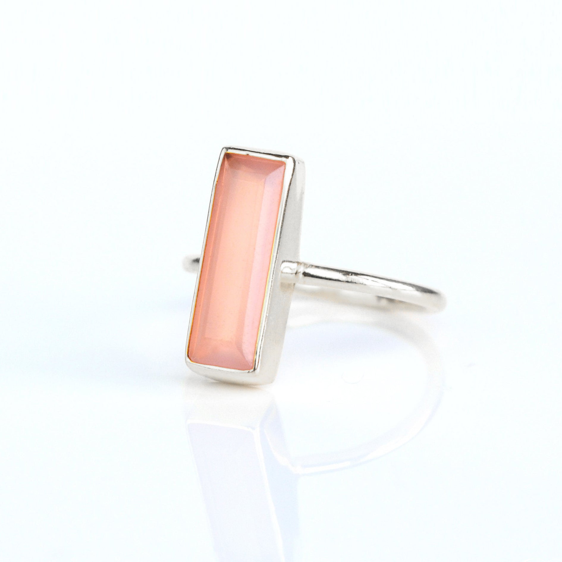 October birthstone ring, Pink Chalcedony gemstone, soft pink Chalcedony bar design, unique minimalist ring, bezel-set gemstone, Adira Series, fashionable pink Chalcedony ring, elegant jewelry, eye-catching accessory, stylish pink gemstone