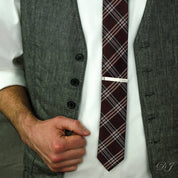 Engraved silver tie clip on a groomsman.