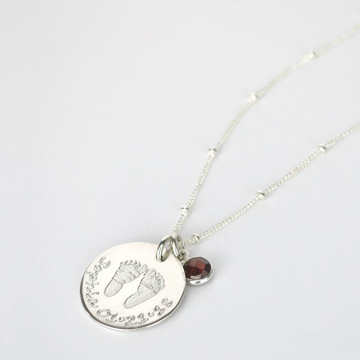 Each necklace can be made with your baby’s actual footprints or handprints! We do have stock footprints or handprints available. Both sides can be engraved - engrave the back with baby's birth stats such as birth time, weight and length