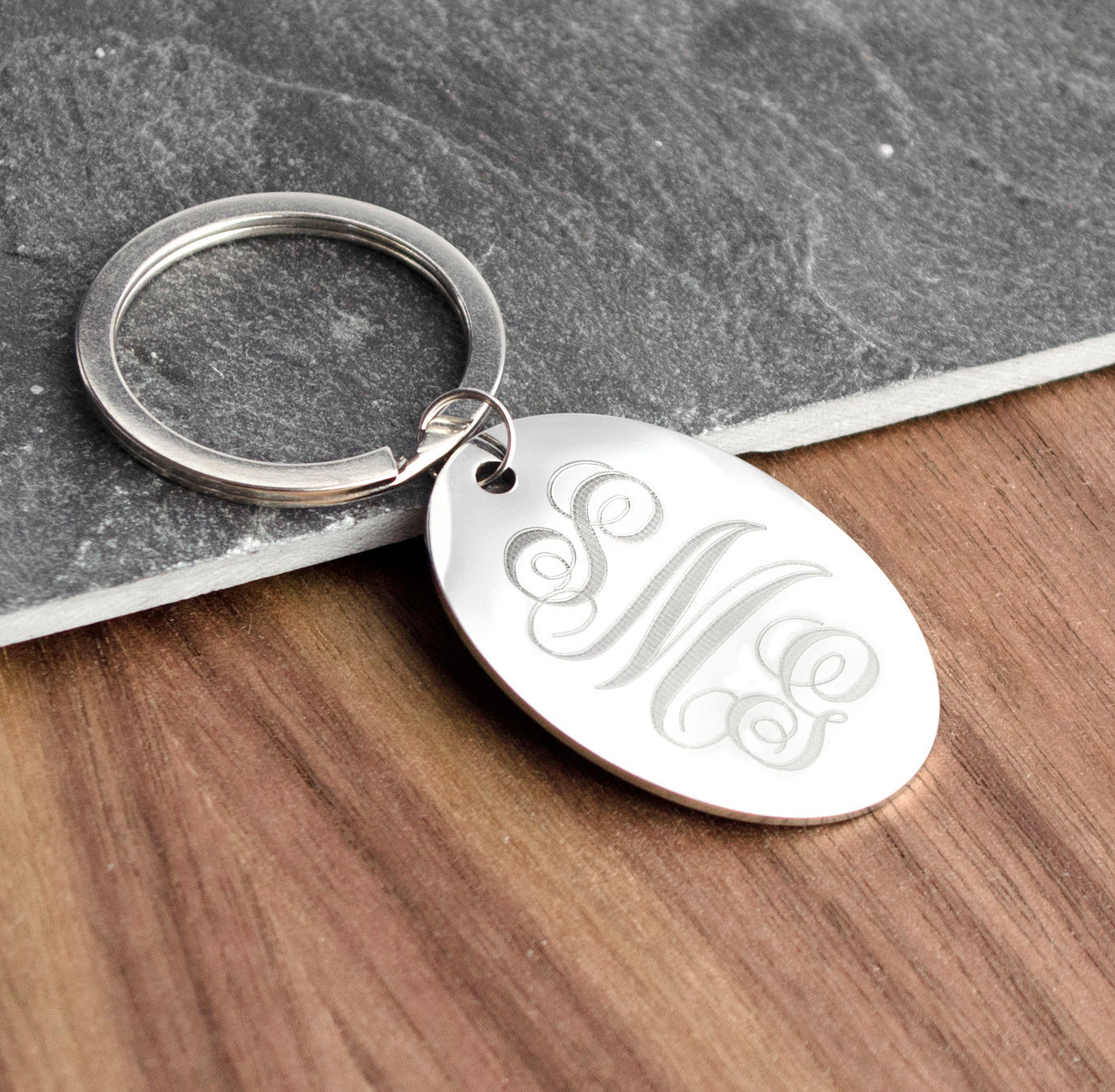 Engrave a monogram - Swirly example - onto your keychain. Make this stand out with one of our stylish monograms. 