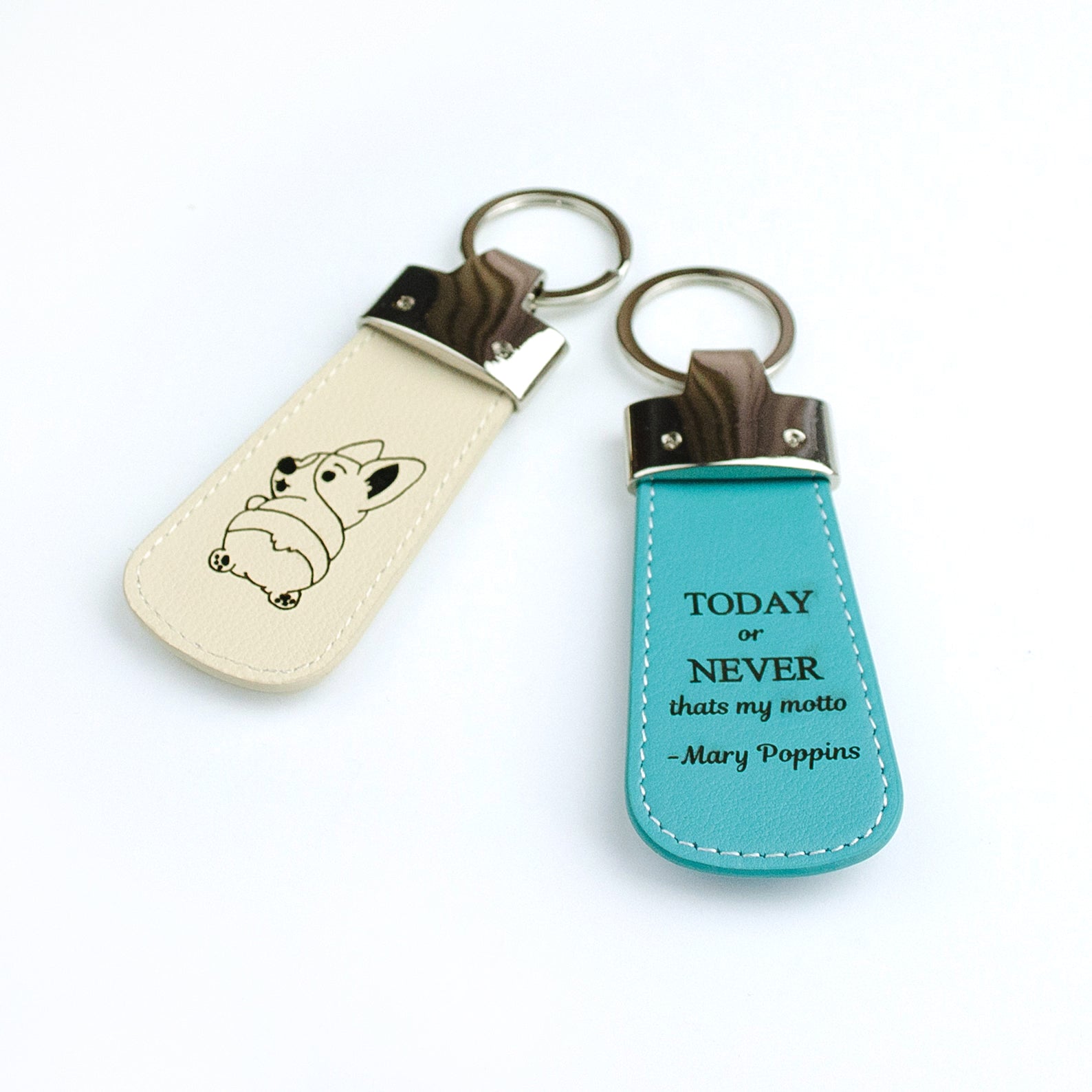 Two custom leather paddle keychains. Nude keyfob with dog photo or illustration, turquoise keychain with popular mary poppins quote.