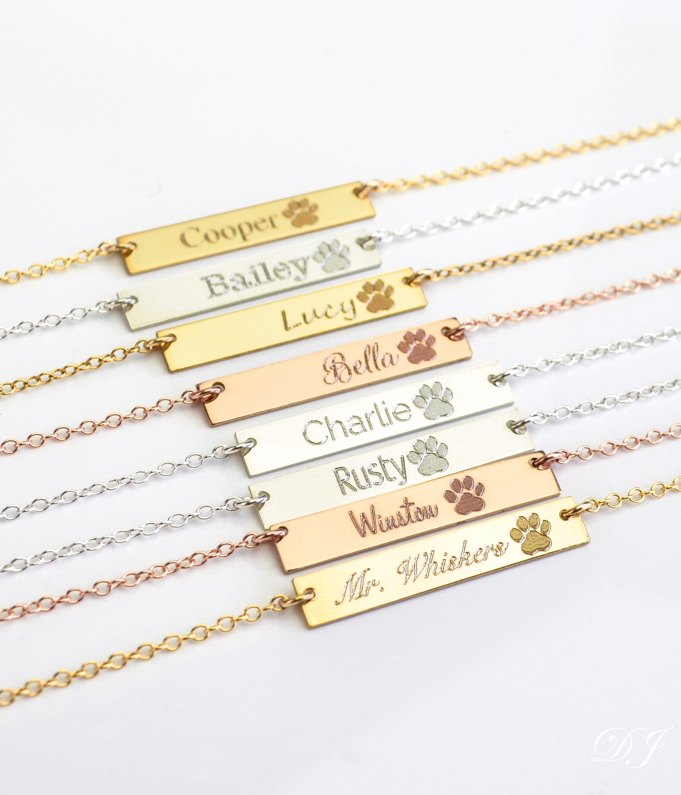 Multiple paw print bar necklaces in a variety of fonts. Pet memorial bar necklace, engraved pet jewelry, custom pet name necklace, sterling silver bar necklace, gold-filled pet necklace, rose gold-filled necklace, personalized pet remembrance gift, dog mom gift, pet owner jewelry, pet tribute necklace, engraved pet charm