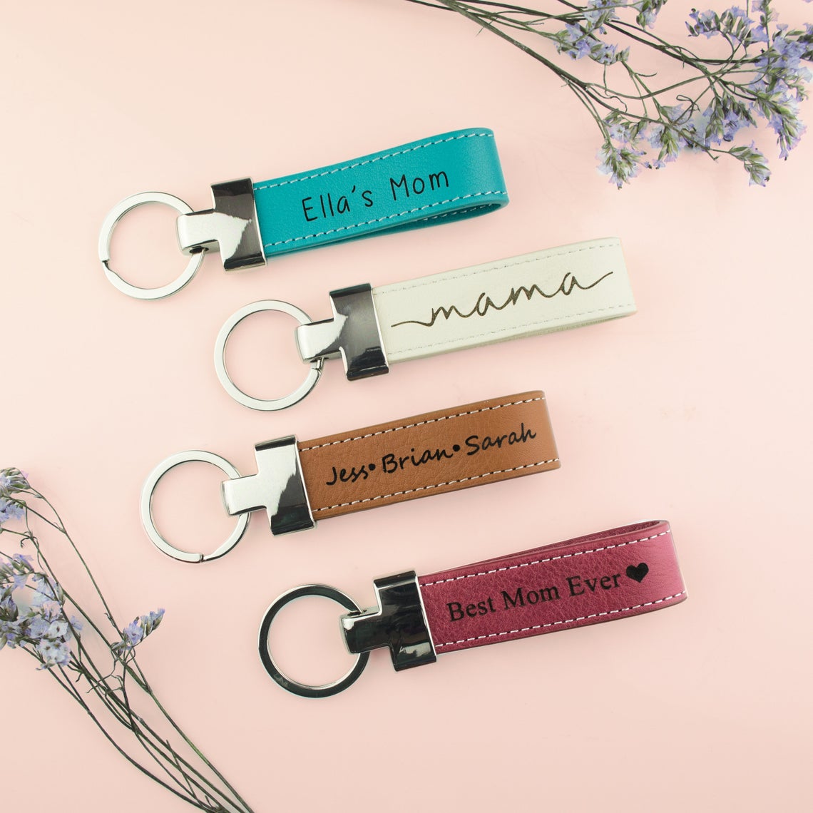 Four Genuine Leather Loop Keychains Custom Engraved with Text. Turquoise Leather Keychain engraved with "Ella's Mom", White Leather Keychain Loop with Mama engraved, Brown Leather Keychain Loop engraved with names, Raspberry Red Leather Custom Engraved with "Best Mom Ever" and a heart. Personalize text engraved leather keychain, Mother's Day gift, Keychain Gift for Mom